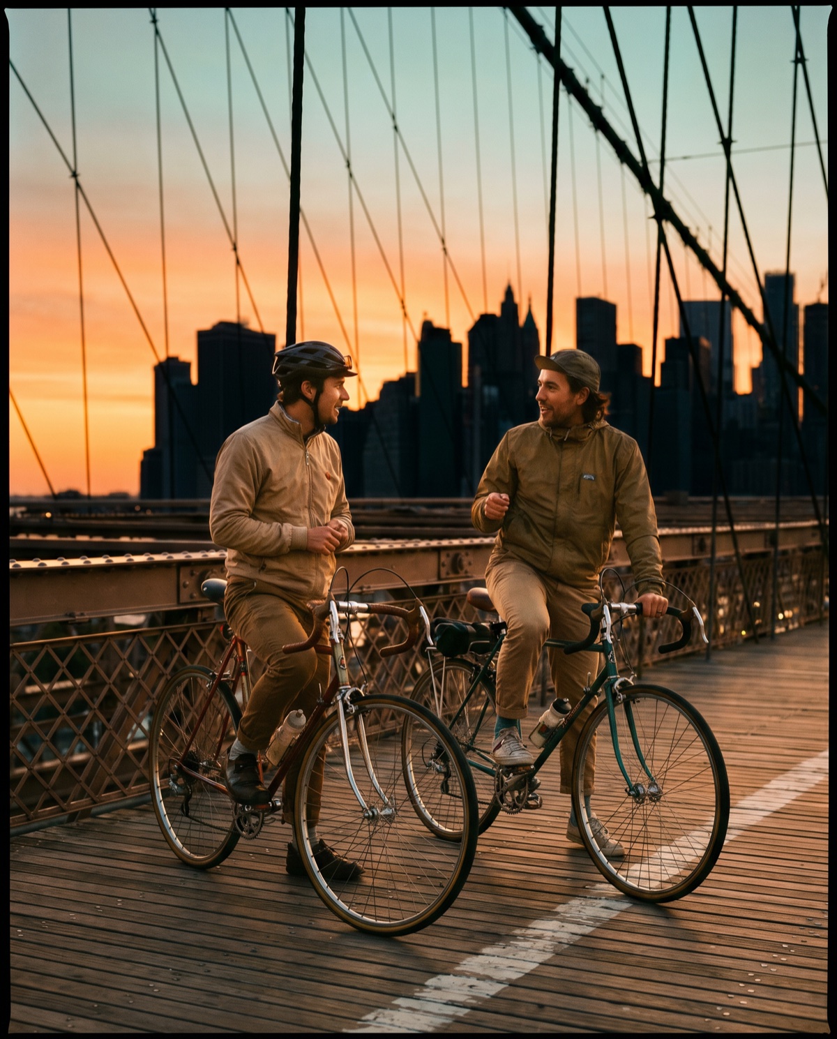 Cyclists rolling across the Brooklyn Bridge at sunrise